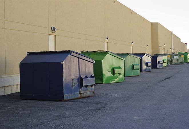 construction workers disposing of debris in large dumpsters in Ennis